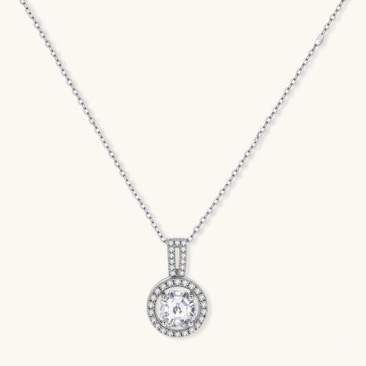 Platinum-plated sterling silver necklace with round halo pendant featuring central crystal surrounded by smaller stones